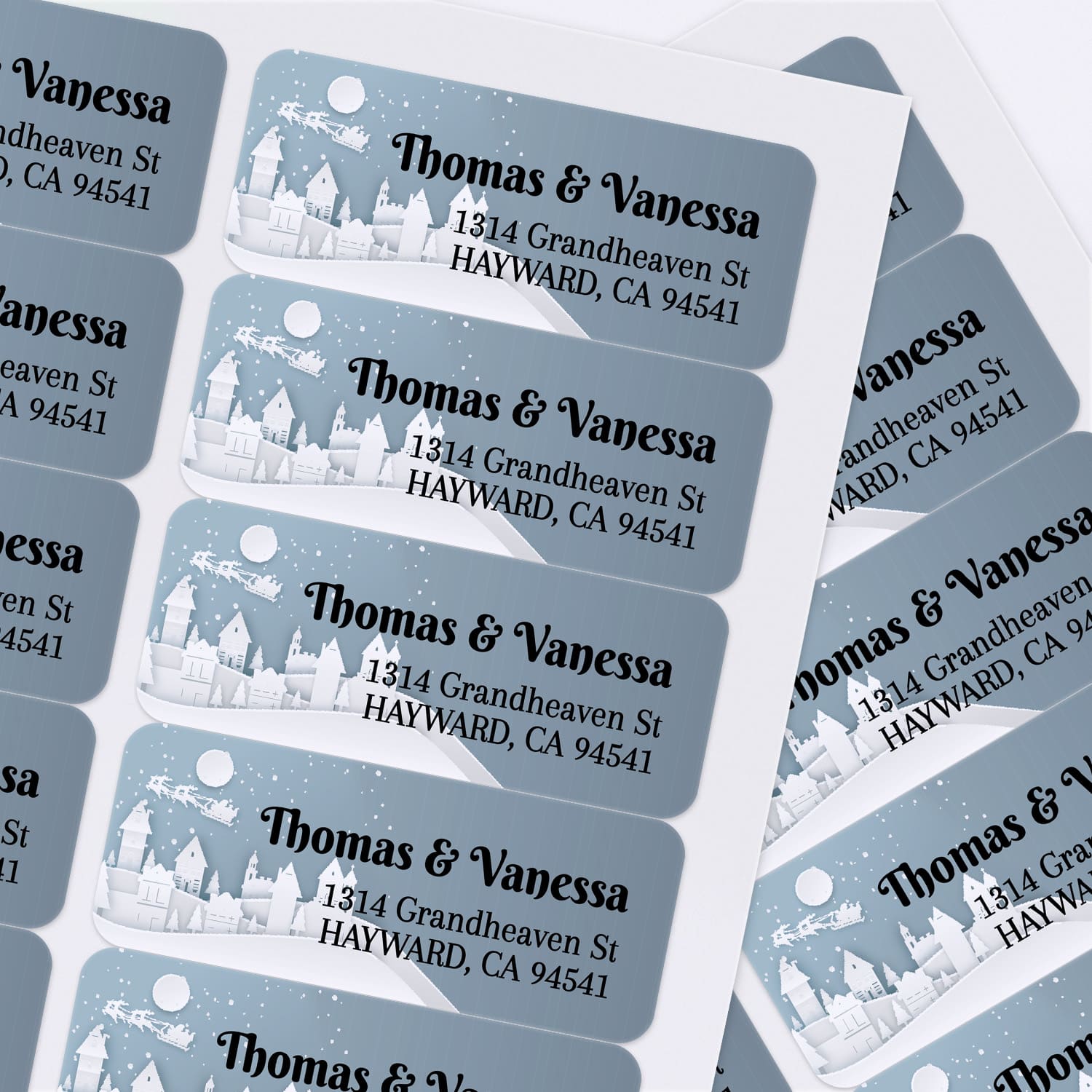 Sheet of personalized winter-themed return address stickers with snowy town landscape and festive typography for holiday cards - XOXOKristen