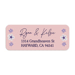 Close-up of pink floral return address label with whimsical purple flower illustrations and stylish handwritten typography - XOXOKristen