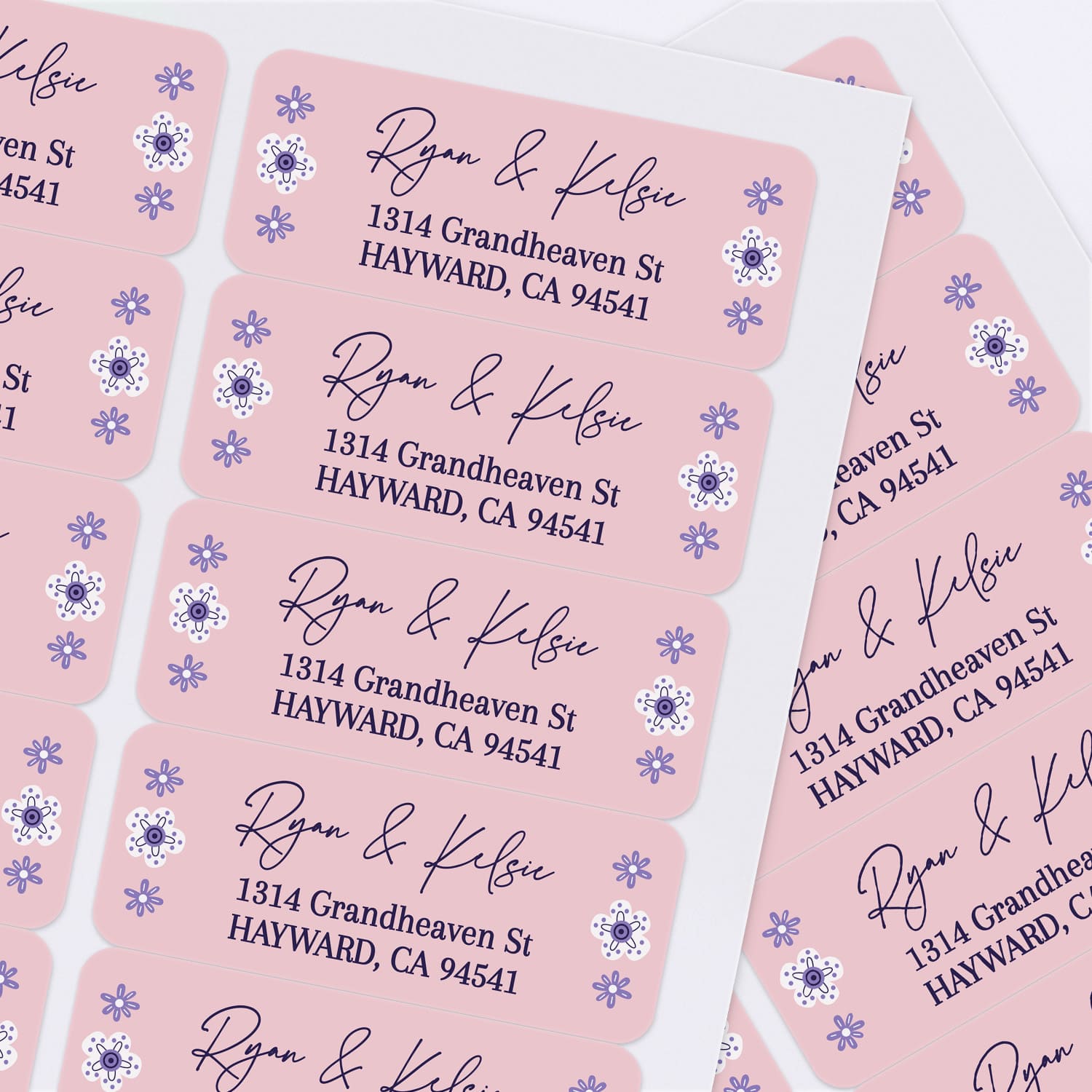 Sheet of personalized pink return address labels with floral accents and modern script font, perfect for weddings, parties, and everyday mailing - XOXOKristen