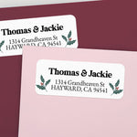 Custom Christmas return address labels on pink and burgundy envelopes, decorated with festive holly branch motifs and printed text - XOXOKristen