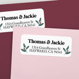 Custom Christmas return address labels on pink and burgundy envelopes, decorated with festive holly branch motifs and printed text - XOXOKristen