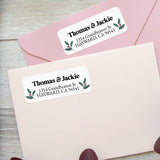 Close-up of holly berry return address label featuring traditional green leaves and red berries with bold black font - XOXOKristen