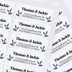 Custom Christmas return address labels on pink and burgundy envelopes, decorated with festive holly branch motifs and printed text - XOXOKristen