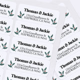 Custom Christmas return address labels on pink and burgundy envelopes, decorated with festive holly branch motifs and printed text - XOXOKristen
