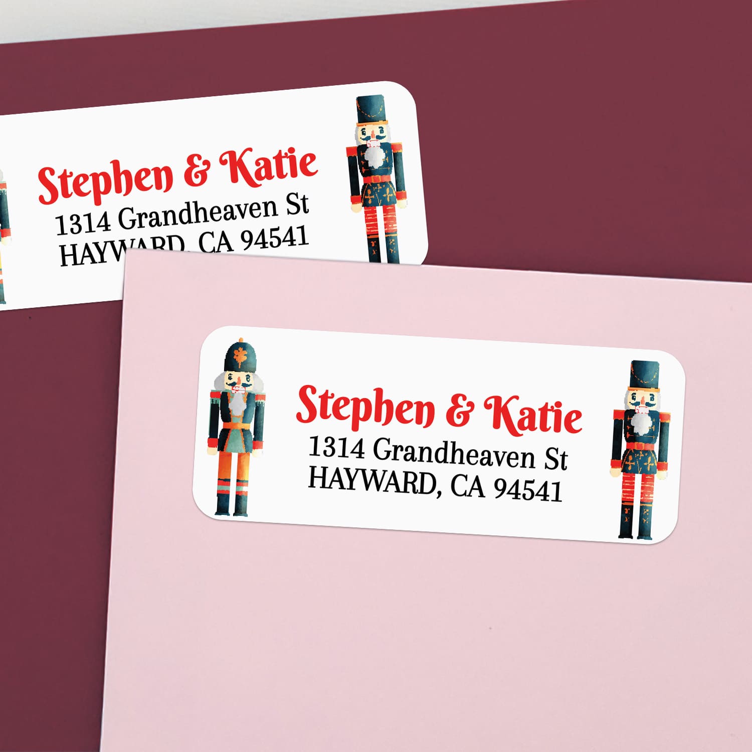 Custom nutcracker return address labels on pink and burgundy envelopes, featuring Christmas soldier design and elegant printed text - XOXOKristen