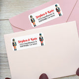 Close-up of holiday return address sticker with traditional nutcracker soldier graphics and bold red script paired with classic black font - XOXOKristen