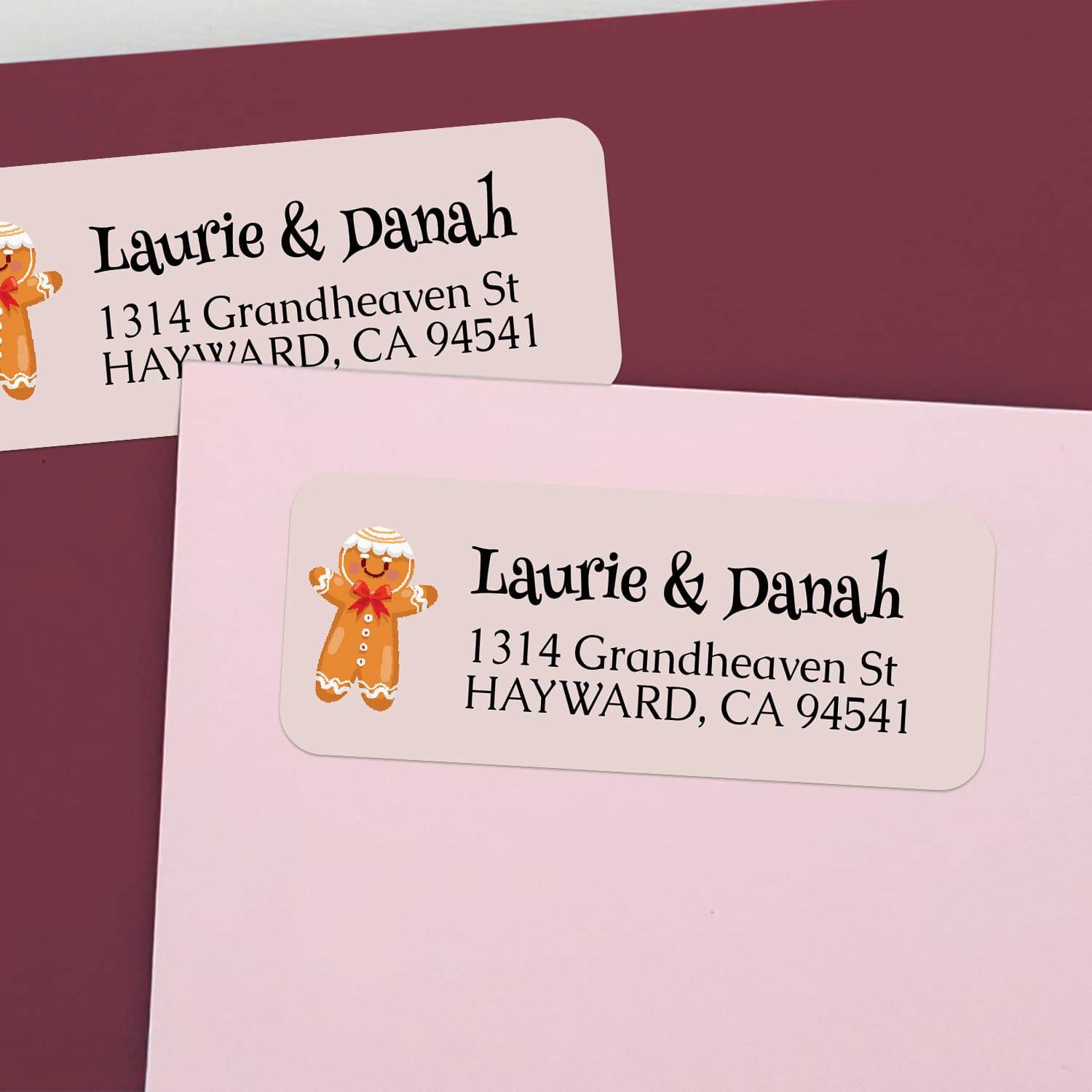 Custom holiday return address labels on pink and burgundy envelopes, decorated with gingerbread cookie motif and cheerful printed text - XOXOKristen
