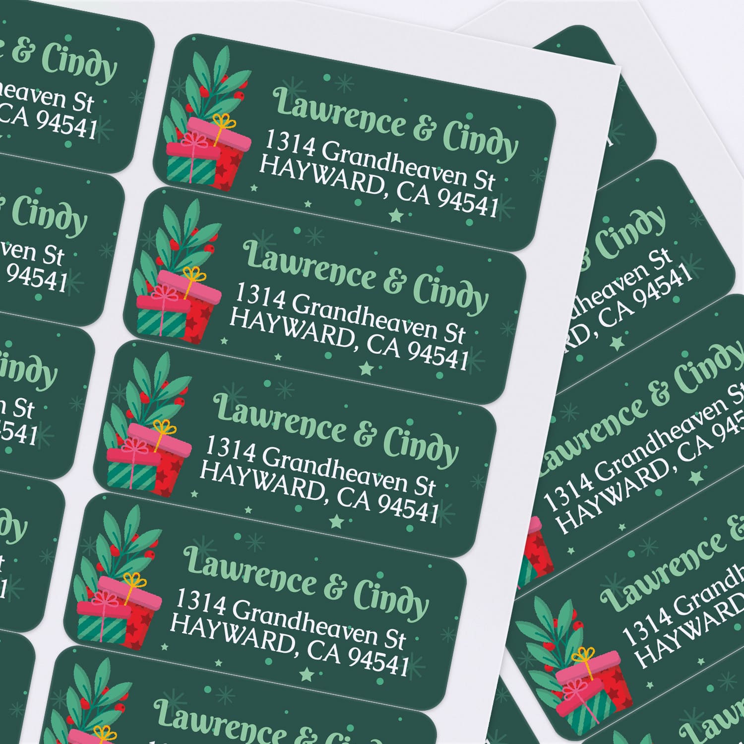 Custom Christmas label design with red and green gift boxes, star accents, and personalized white text on dark green background – XOXOKristen