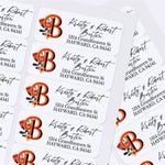 Sheet of custom printed address labels with vibrant orange monogram, floral accents, and stylish script font, designed for envelopes and mailing - XOXOKristen