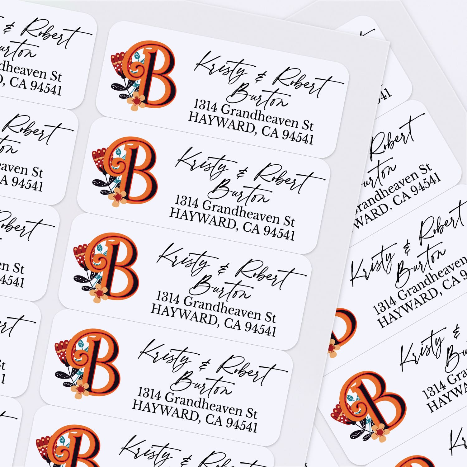 Sheet of custom printed address labels with vibrant orange monogram, floral accents, and stylish script font, designed for envelopes and mailing - XOXOKristen