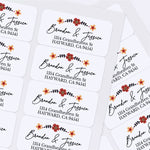 Sheet of custom floral return address stickers with elegant calligraphy and printed addresses, displayed on white background — XOXOKristen.