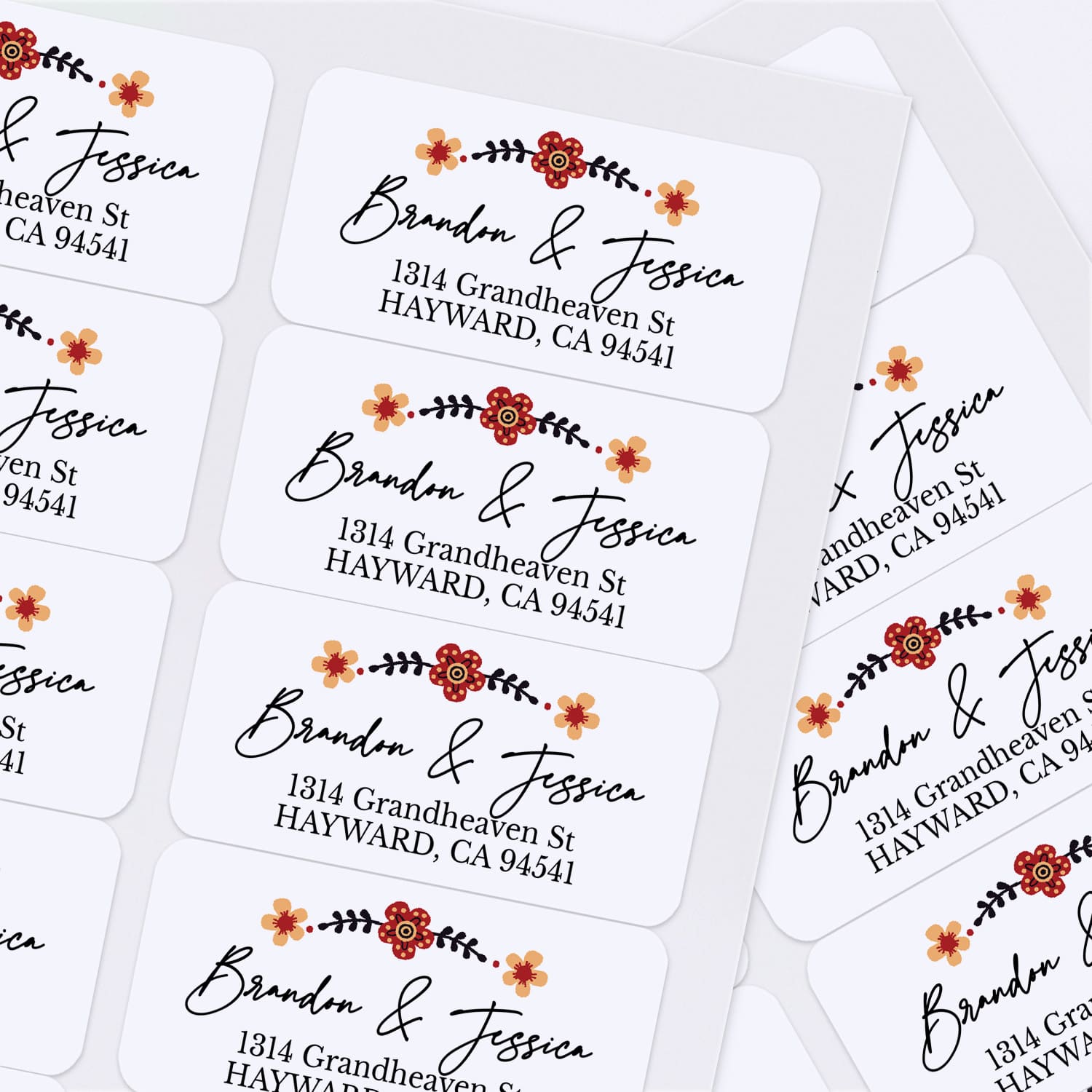 Sheet of custom floral return address stickers with elegant calligraphy and printed addresses, displayed on white background — XOXOKristen.