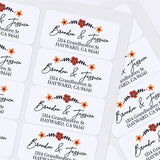 Sheet of custom floral return address stickers with elegant calligraphy and printed addresses, displayed on white background — XOXOKristen.