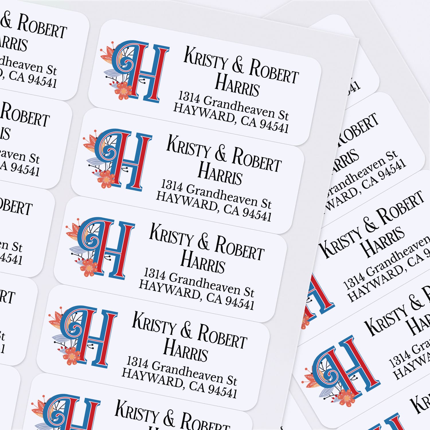Sheet of personalized return address labels showing repeating monogram H with floral accents and black serif typography for names and address - XOXOKristen