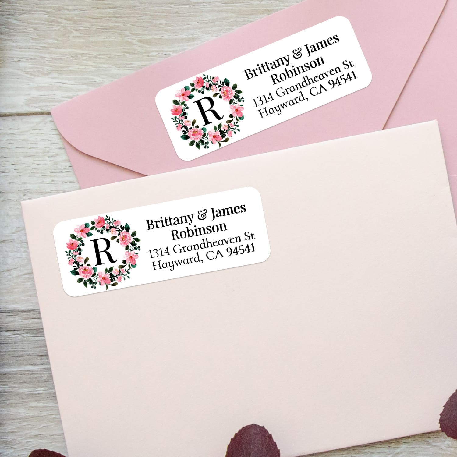 XOXOKristen custom floral wreath address labels on pastel pink envelopes, featuring soft watercolor-style roses and elegant serif text - XOXOKristen