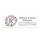 XOXOKristen close-up of return address label with delicate pink flowers arranged in a circular wreath around bold monogram initial - XOXOKristen