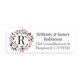 XOXOKristen close-up of return address label with delicate pink flowers arranged in a circular wreath around bold monogram initial - XOXOKristen