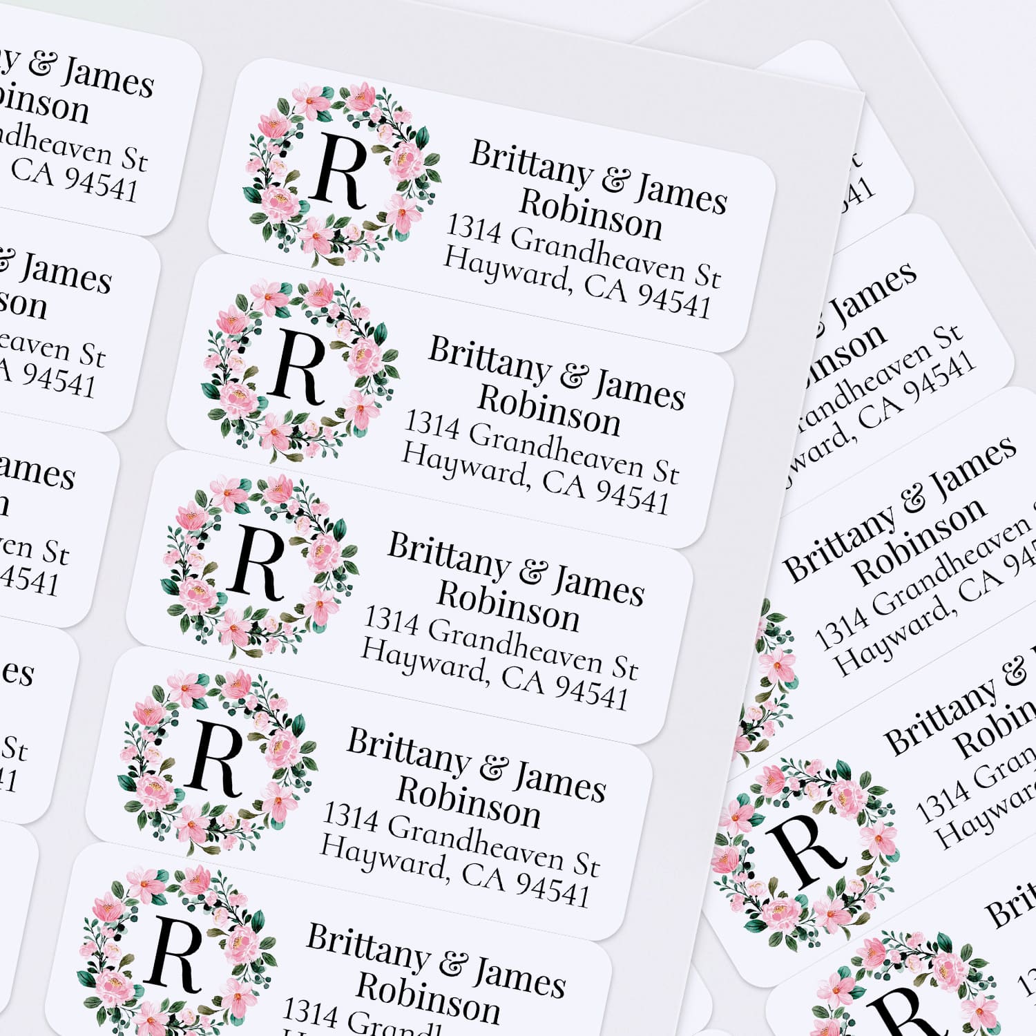 XOXOKristen sheet of multiple personalized floral wreath return address labels with leafy greenery, soft pink blossoms, and monogram detail - XOXOKristen