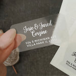 Custom clear glossy address label with white ink, featuring modern calligraphy names and block address font, applied on envelope - XOXOKristen