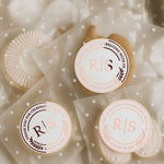 XOXOKristen personalized clear wedding stickers with rose gold foil, round shape, perfect for sealing cookie favor bags at elegant wedding receptions.