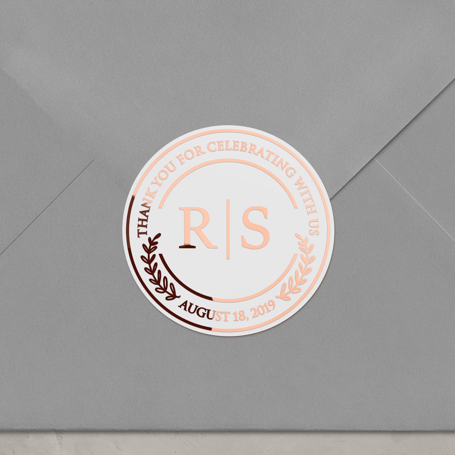 XOXOKristen foiled wedding sticker on envelope, round clear label with rose gold metallic text, ideal for sealing invitations and thank you notes.