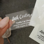 Clear transparent vinyl branding label with glossy finish, modern script and serif typography design shown up close – XOXOKristen.
