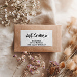Kraft paper envelope sealed with rectangular black print branding sticker, styled with dried flowers for natural rustic look – XOXOKristen.