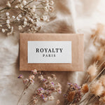 Kraft paper envelope with minimalist black serif rectangular branding label, styled with dried flowers for rustic packaging – XOXOKristen.