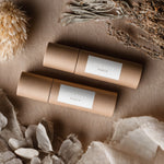 Kraft tubes wrapped with silver foil rectangular branding labels, minimalist serif design shown in eco luxury packaging – XOXOKristen.