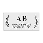 Rectangular wedding favor label with bold serif initials in the center and botanical sprigs on both sides, minimalist black print – XOXOKristen.