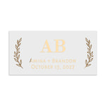 Rectangular wedding favor sticker in metallic gold foil, designed with bold serif initials and symmetrical botanical sprigs – XOXOKristen.