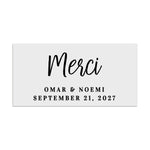 Rectangular wedding favor label with elegant handwritten Merci script headline and serif subtext, minimalist black print design – XOXOKristen.