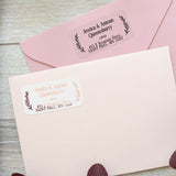 XOXOKristen gold foil personalized return address label with laurel leaf accents, printed on clear PVC vinyl, shown applied to navy envelope - XOXOKristen