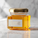 Small white matt PVC rectangular label with ingredients, printed in gold foil and applied over a jar of honey- XOXOKristen