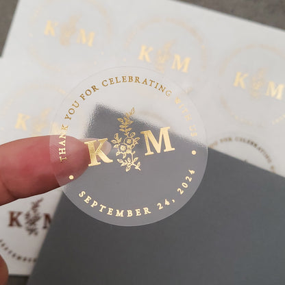 gold foiled monogram wedding favor sticker with thank you for celebrating with us text and floral design, personalized with initials and wedding date -  XOXOKristen