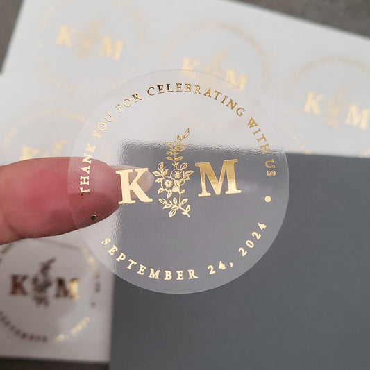 gold foiled monogram wedding favor sticker with thank you for celebrating with us text and floral design, personalized with initials and wedding date -  XOXOKristen
