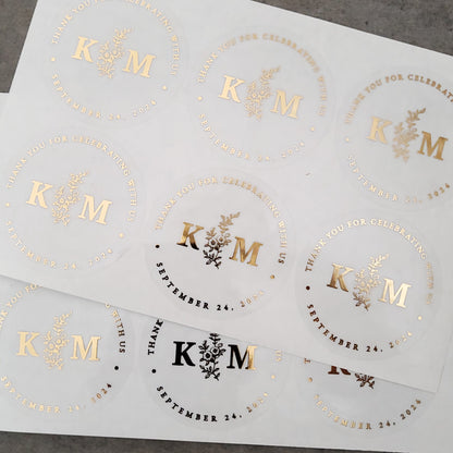 gold foiled monogram wedding favor sticker with thank you for celebrating with us text and floral design, personalized with initials and wedding date -  XOXOKristen