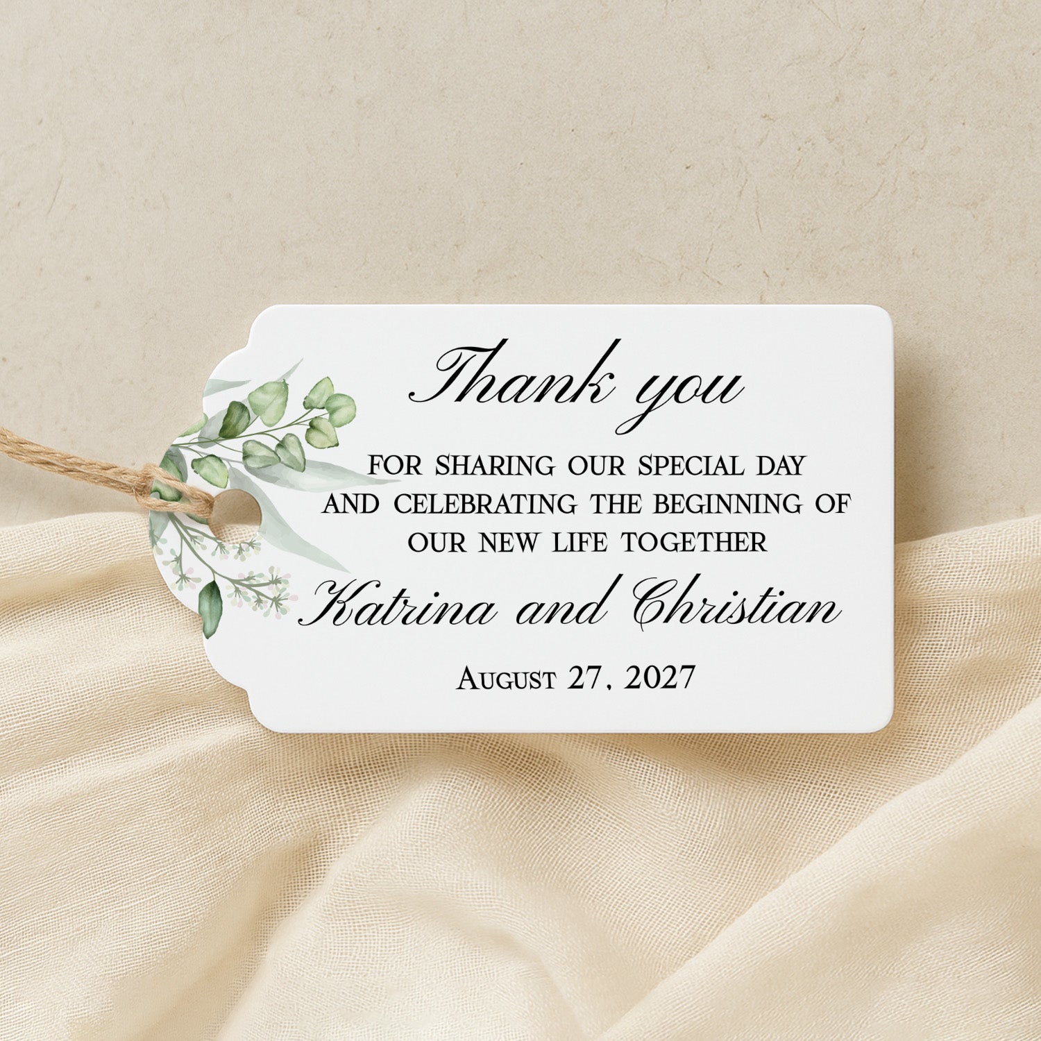 XOXOKristen Greenery Wedding Thank You Tag placed on soft beige fabric — minimalist botanical design, personalized and custom tag for weddings.