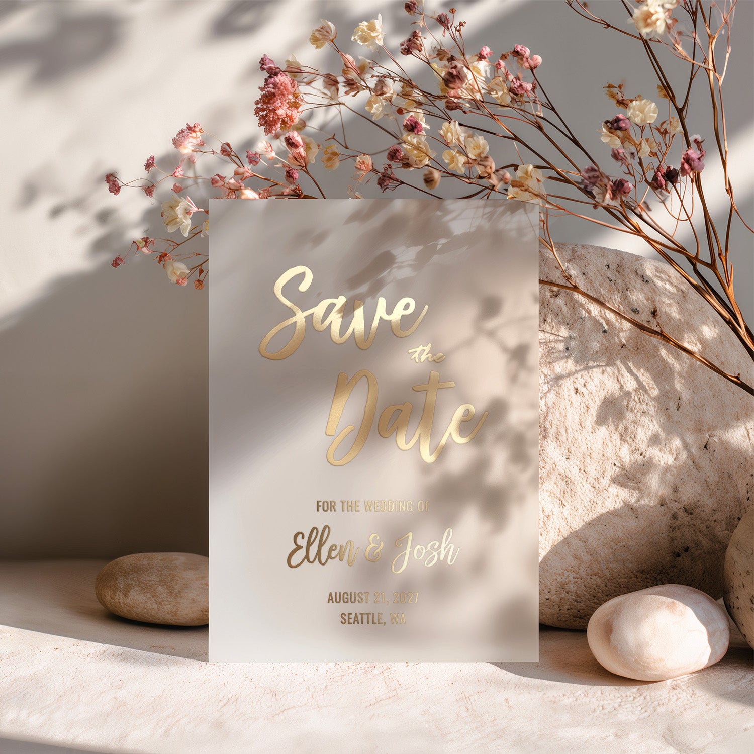 XOXOKristen translucent vellum Save the Date card printed in metallic gold foil, standing upright against soft background with dried floral decor and natural light – XOXOKristen.