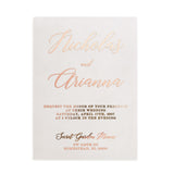 Acrylic-like translucent vellum wedding invitation standing upright under soft sunlight, surrounded by neutral décor and floral stems. Sophisticated modern style ideal for luxury wedding stationery. - XOXOKristen