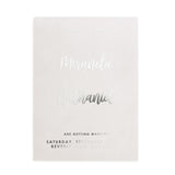 Modern vellum Save the Date card printed in silver foil, styled in warm sunlight among florals and natural textures – XOXOKristen
