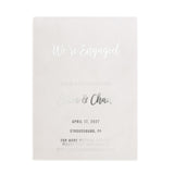 A silver foil version of the engagement Save the Date card photographed against a white backdrop. The metallic finish gives a cool, modern appearance suited for contemporary weddings - XOXOKristen