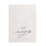 Elegant silver-foil vellum invitation displayed under natural light with floral stems and soft shadows, perfect for luxury wedding stationery mockups – XOXOKristen.