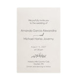 Elegant frosted translucent vellum wedding invitation printed with refined black serif and cursive script with the couples’ names, surrounded by white blossoms and soft beige tones under gentle sunlight. XOXOKristen
