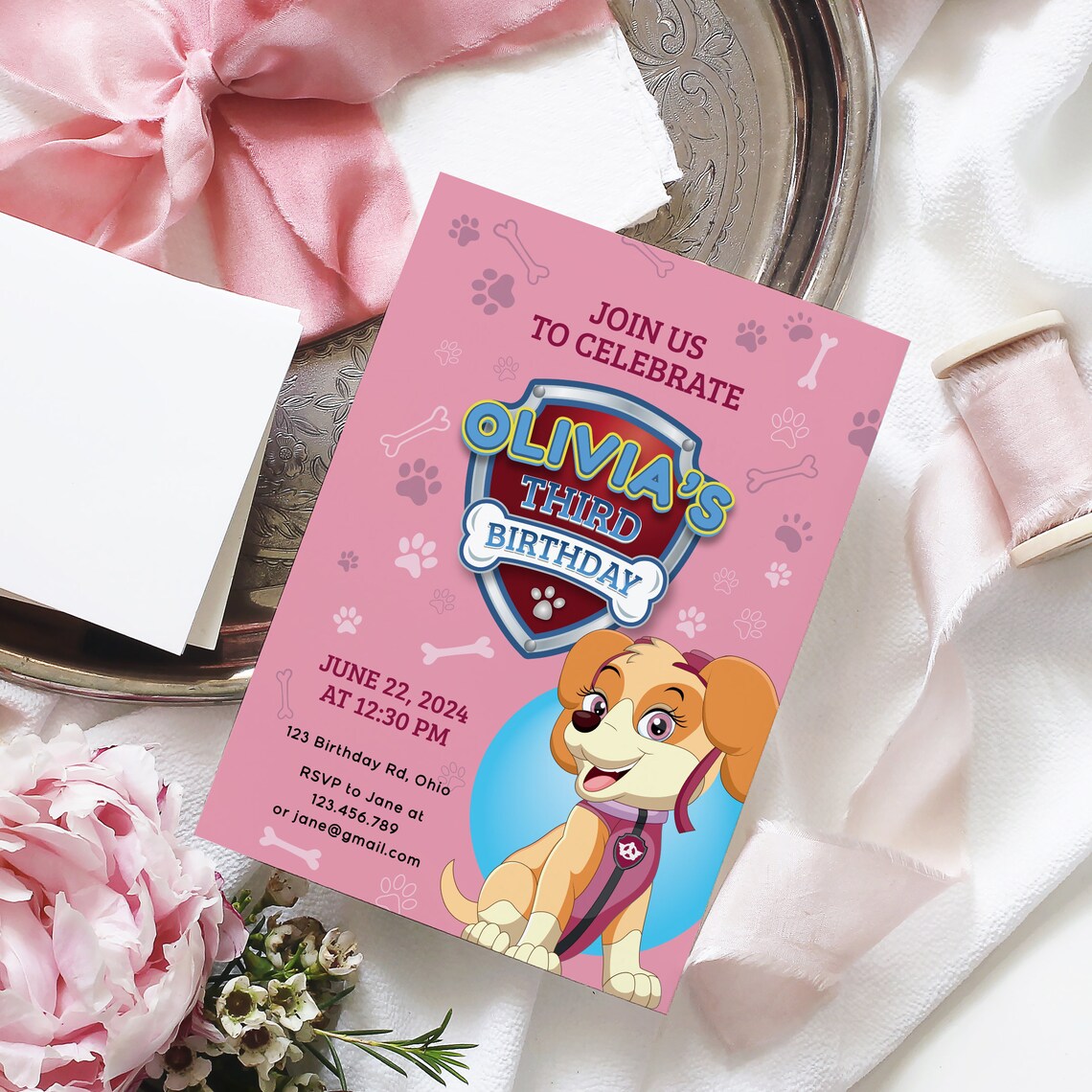first birthday invitation for a baby girl with pink design featuring little cartoon dog