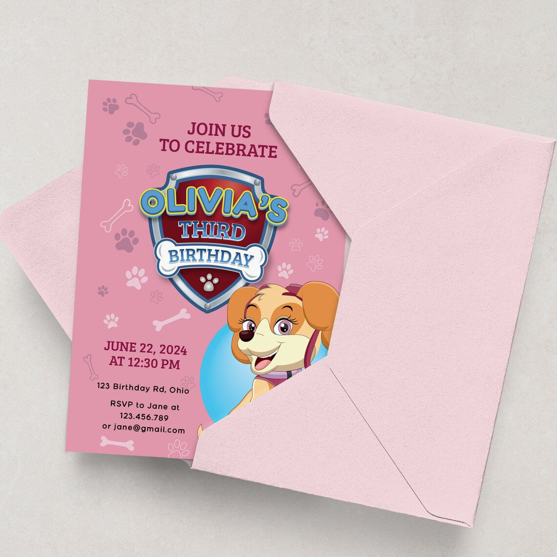 first birthday invitation for a baby girl with pink design featuring little cartoon dog