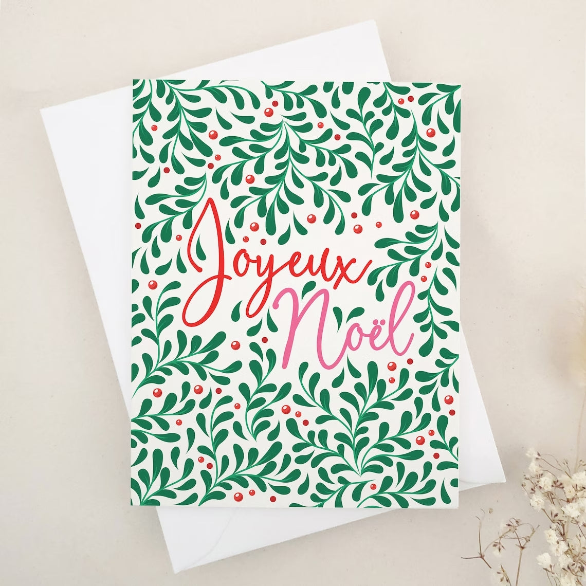 Festive 'Joyeux Noël' Holiday Card with Green and Red Botanical Design