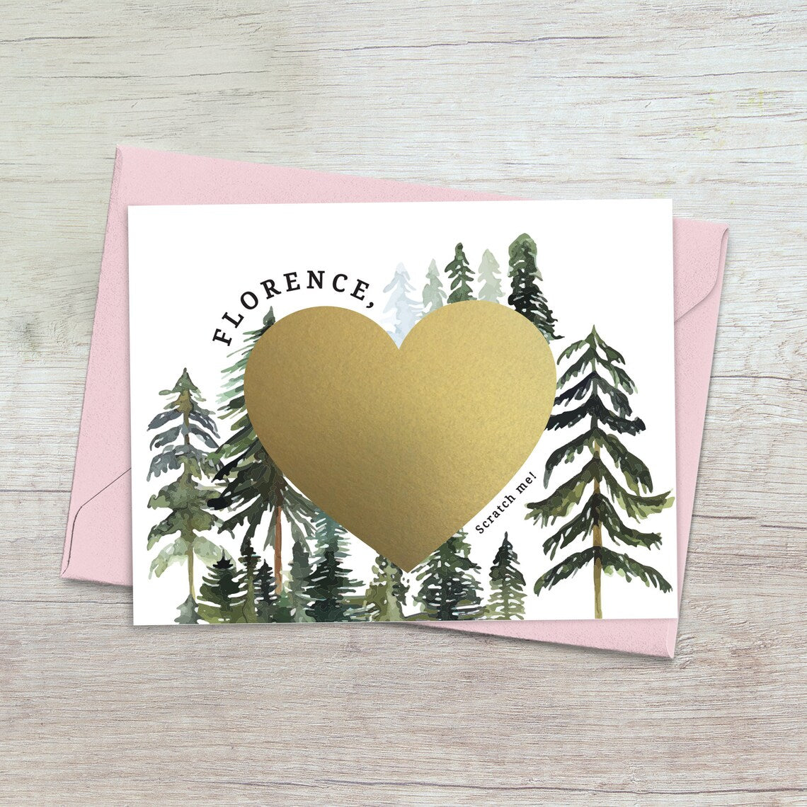 will you be my bridesmaid proposal card with rustic pine trees design and gold foiled cratch off heart in the middle. 