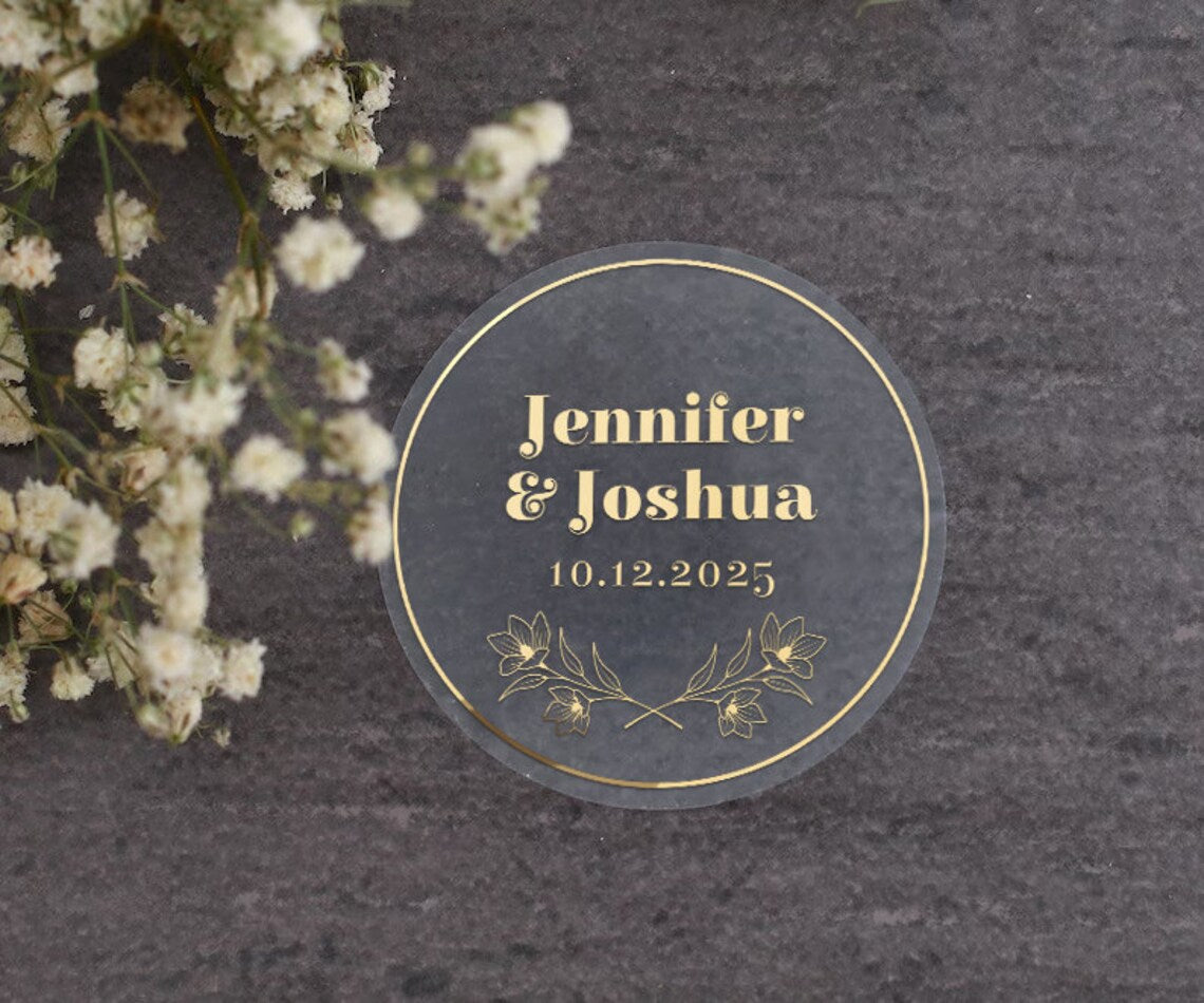 Personalized wedding sticker with bold names, date, and floral branches on clear background