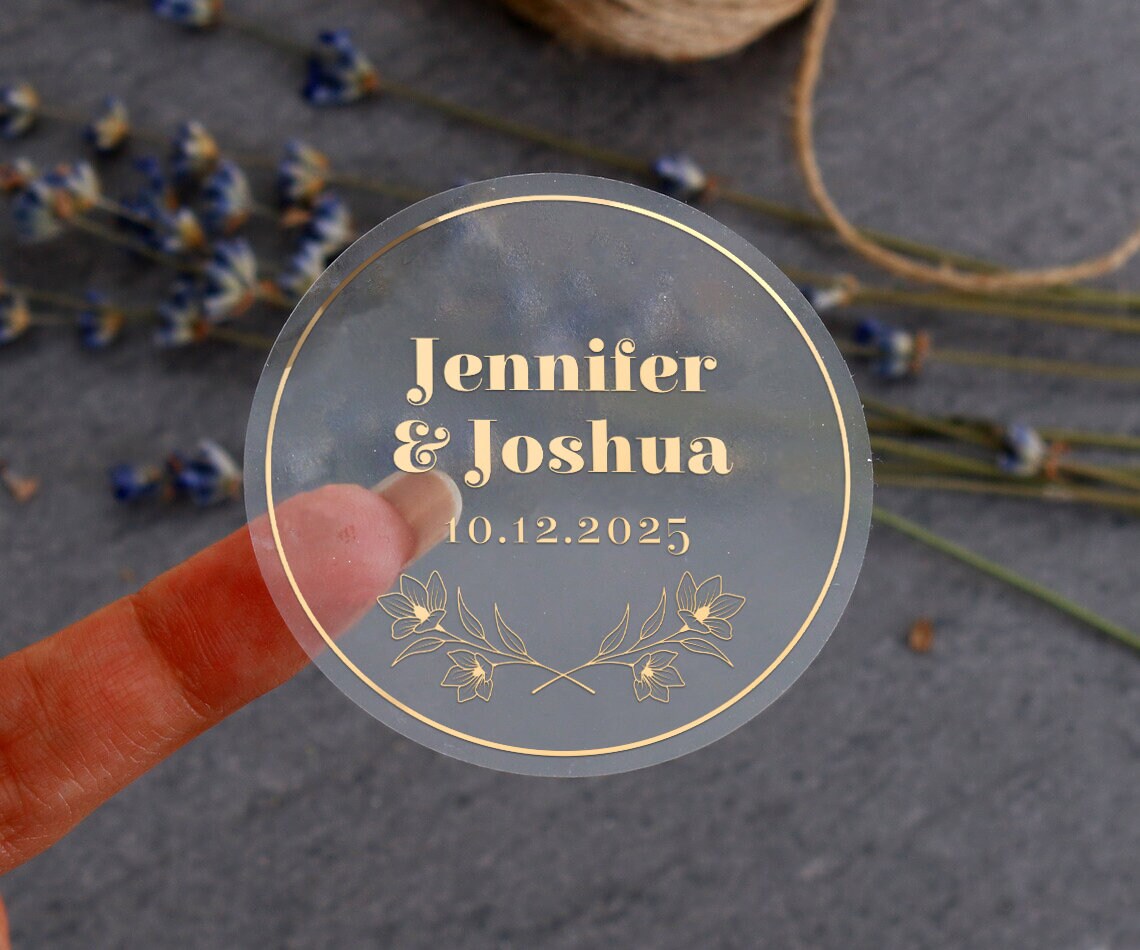 Personalized wedding sticker with bold names, date, and floral branches on clear background